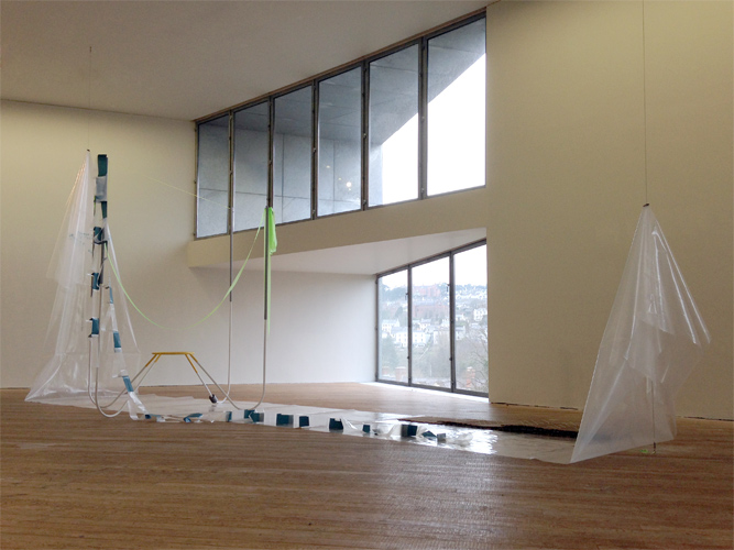 Maud Cotter 'A Network of Relations in the Field of the Sun' 3.5m high × 6.5m long × 2m wide (approx), steel, high–tension stainless steel cables, mason's line, flag tape, card, cable ties, plastic sheeting, hair–tie, dental plaster, installation view from '2116' at the Glucksman Gallery Cork, Ireland.