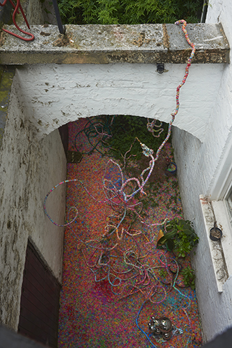 Mhairi Vari 'dimly visible (repeater)' 2019 loom bands, gazing balls, stress balls, ball bearings, hot melt glue and plant matter,5×2×3m approx, photo by Andy Keate