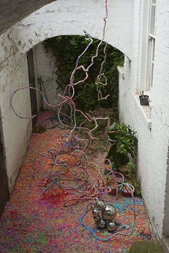 Mhairi Vari 'dimly visible (repeater)' 2019 loom bands, gazing balls, stress balls, ball bearings, hot melt glue and plant matter,5×2×3m approx, photo by Andy Keate