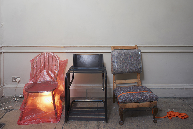 Aubrey Haskard 'Chair 1, 2, 3' 2019, latex resistance bands, furniture blankets, surround wrap, bin liner, anglepoise lamp, photo by Andy Keate