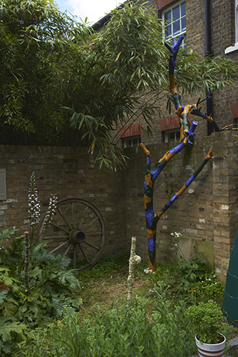 Rupert Ackroyd 'Cart Wheel Exercise' (with David Gates) 2014 (left), Rosa Nguyen 'Two Morris sticks' 2019, wall paper, paint, wood (centre),  Matt Hale 'Ceanothus no.31 Trunk series' 2019, Ceanothus tree (dead), acrylic paint, (right) photo by Andy Keate
