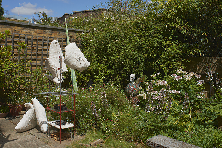 Finn Thomson 'Skewered Forms' 2019, 222×120×60cm, steel, stainless steel, crystacal plaster, fibre, glass, aluminium, wood, oxide paint (left), Andrew Logan 'Portrait of Jen' 1986, collection Jennifer Binnie, mixed media, (right) photo by Andy Keate